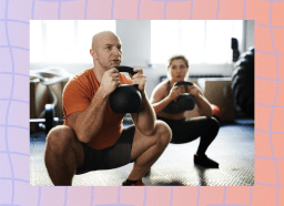 fit man doing kettlebell goblet squat in workout class