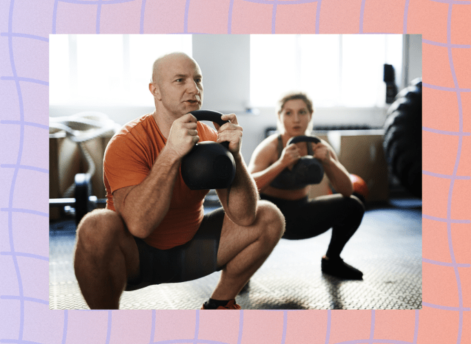 fit man doing kettlebell goblet squat in workout class