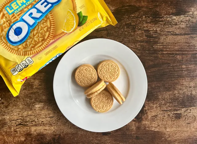 lemon oreos on a plate next to package of golden oreos