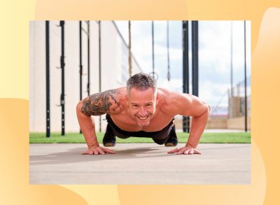 fit, muscular man doing pushups outdoors on sunny day by turf