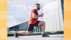 fit man doing walking lunges outdoors while listening to music on phone