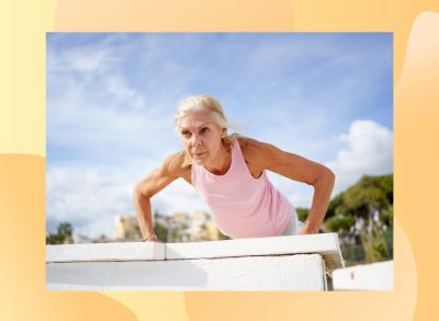 mature blonde woman doing pushups outdoors on a sunny day