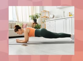 middle-aged woman doing a forearm plank on mat in bright kitchen