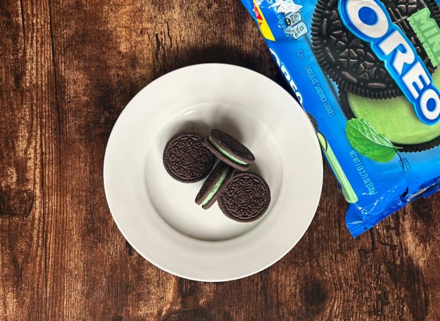 mint oreos on a plate next to a package of mint oreos