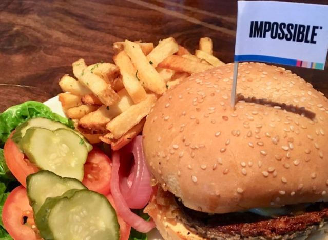 a veggie burger, fries and salad on a plate at oracle park.