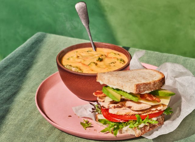 panera grilled chicken & avo melt half next to broccoli cheddar soup