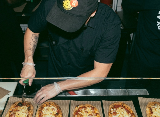 man making pizzas at &pizza.