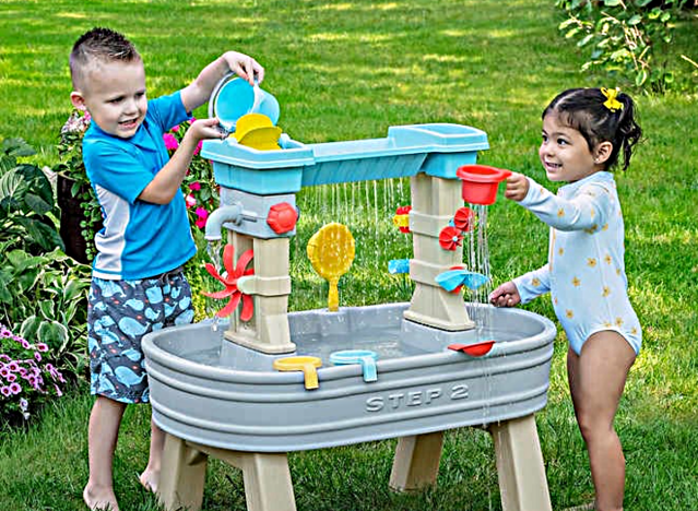 kids playing on a water table.