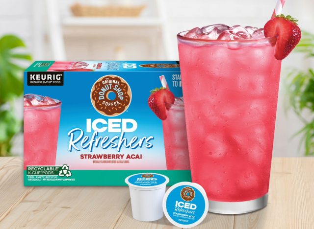the original donut shop box of strawberry acai refreshers next to a glass of the drink and k-cup pods