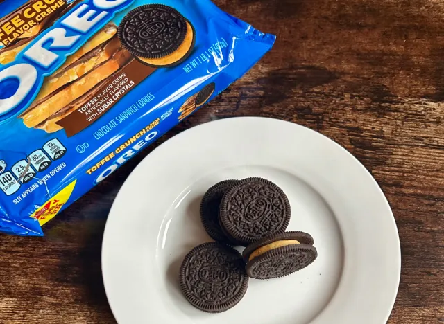 toffee crunch oreos on a plate next to package of chocolate oreos