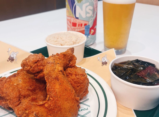 A fried chicken dinner with a beer.