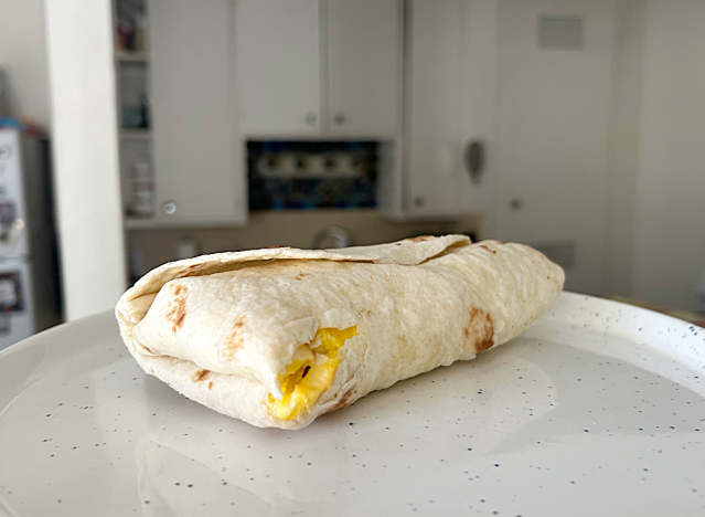 wendys breakfast burrito on a white plate in a kitchen.