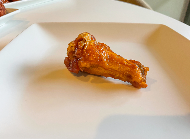 a mild chicken wing on a plate. 