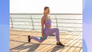 blonde woman in blue athletic sports bra and leggings doing walking lunges while holding blue dumbbells on boardwalk