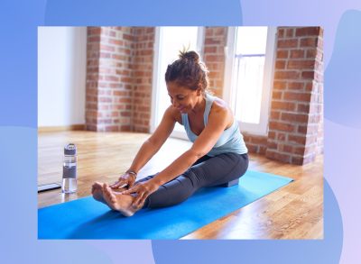 senior woman doing forward fold exercise on a yoga mat