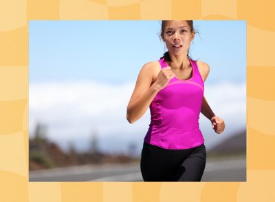 fit woman in hot pink tank and black leggings running outdoors