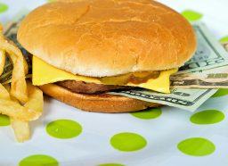 money sandwiched in a fast-food cheeseburger