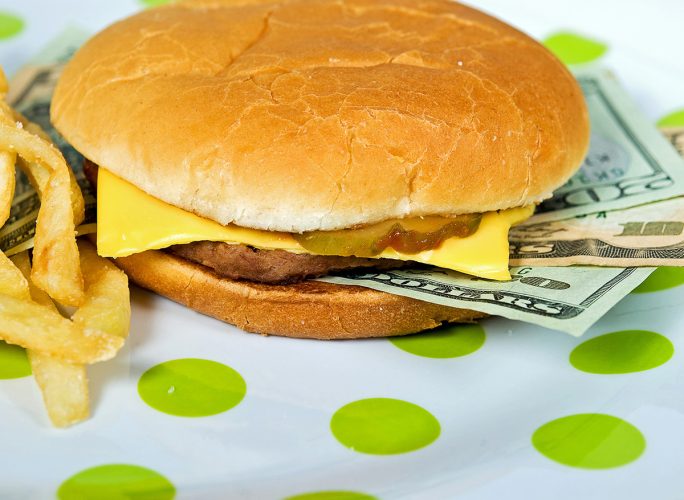 money sandwiched in a fast-food cheeseburger