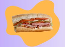 Half of an Italian sub sandwich on a colorful graphic background