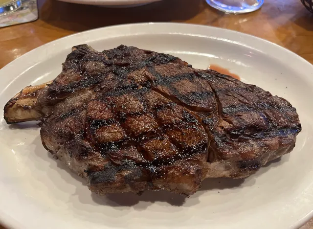 20-ounce bone-in ribeye on a white plate at Texas Roadhouse