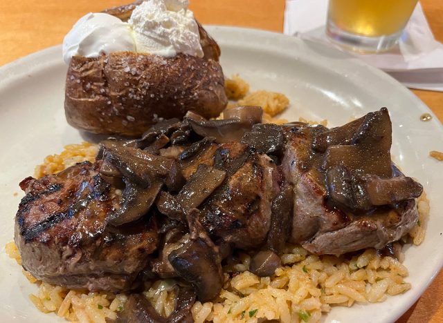 Filet medallions covered in onions and mushrooms and served atop seasoned rice at Texas Roadhouse