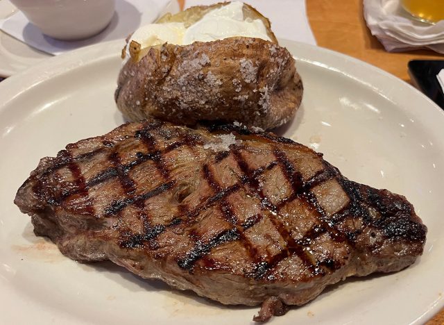 12-ounce New York strip on a white plate at Texas Roadhouse