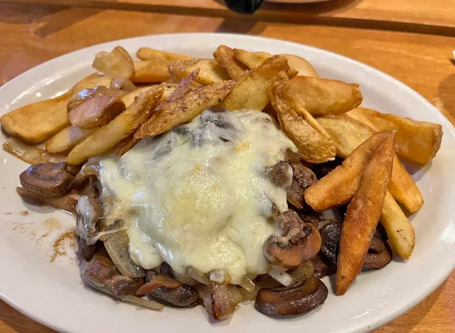 Chopped steak topped with sautéed onions, sautéed mushrooms and jack cheese, aka "Roadkill," at Texas Roadhouse