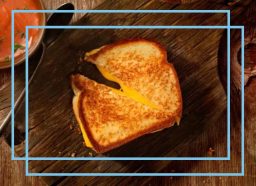 a photo of a grilled cheese sandwich with a blue designed border