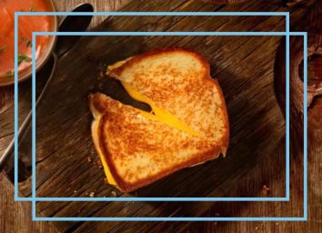 a photo of a grilled cheese sandwich with a blue designed border