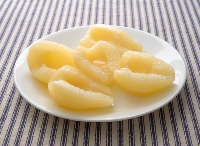 canned pears on white plate
