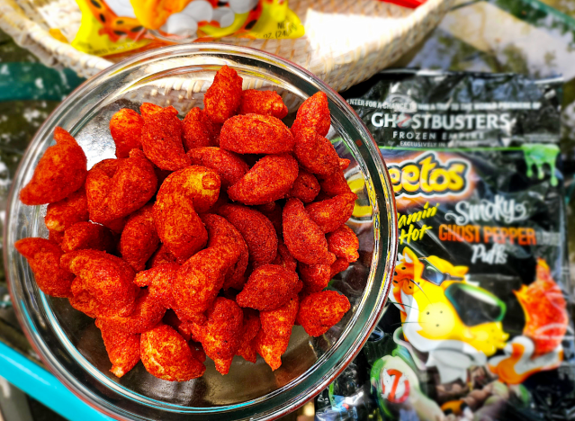 a bowl of cheetos ghost pepper with a bag.