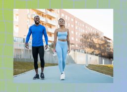 fit couple walking outdoors on paved path