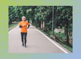 woman in orange t-shirt and black leggings doing walking workout outdoors on walking path surrounded by trees