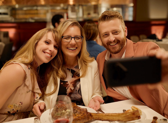 three people enjoying a mother's day lunch at flemings and taking selfies