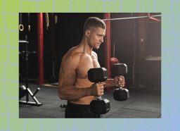 muscular, shirtless man doing hammer curls at the gym