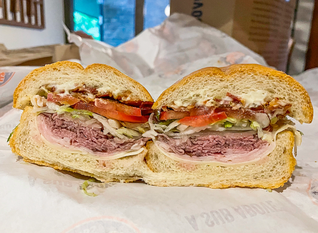 a jersey mike club supreme cut in half on a wrapper.