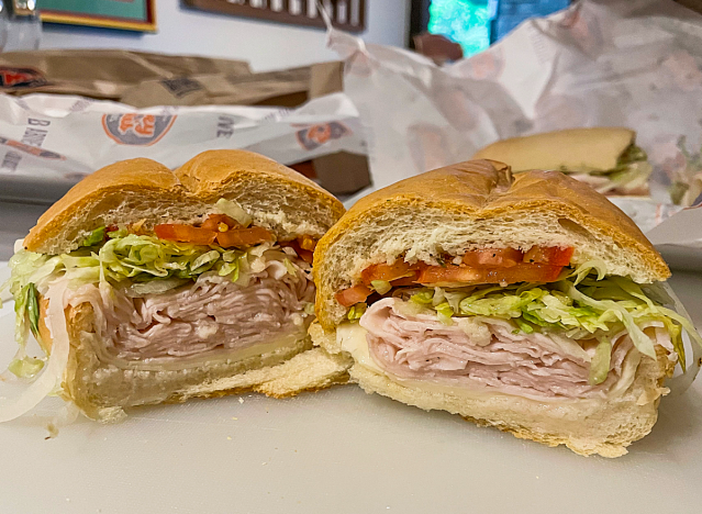 a jersey mike turkey provolone sub cut in half on a wrapper.