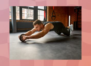 man performing ab rollout in the gym