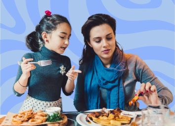 a photo of a mother and daughter at a restaurant on a designed blue background