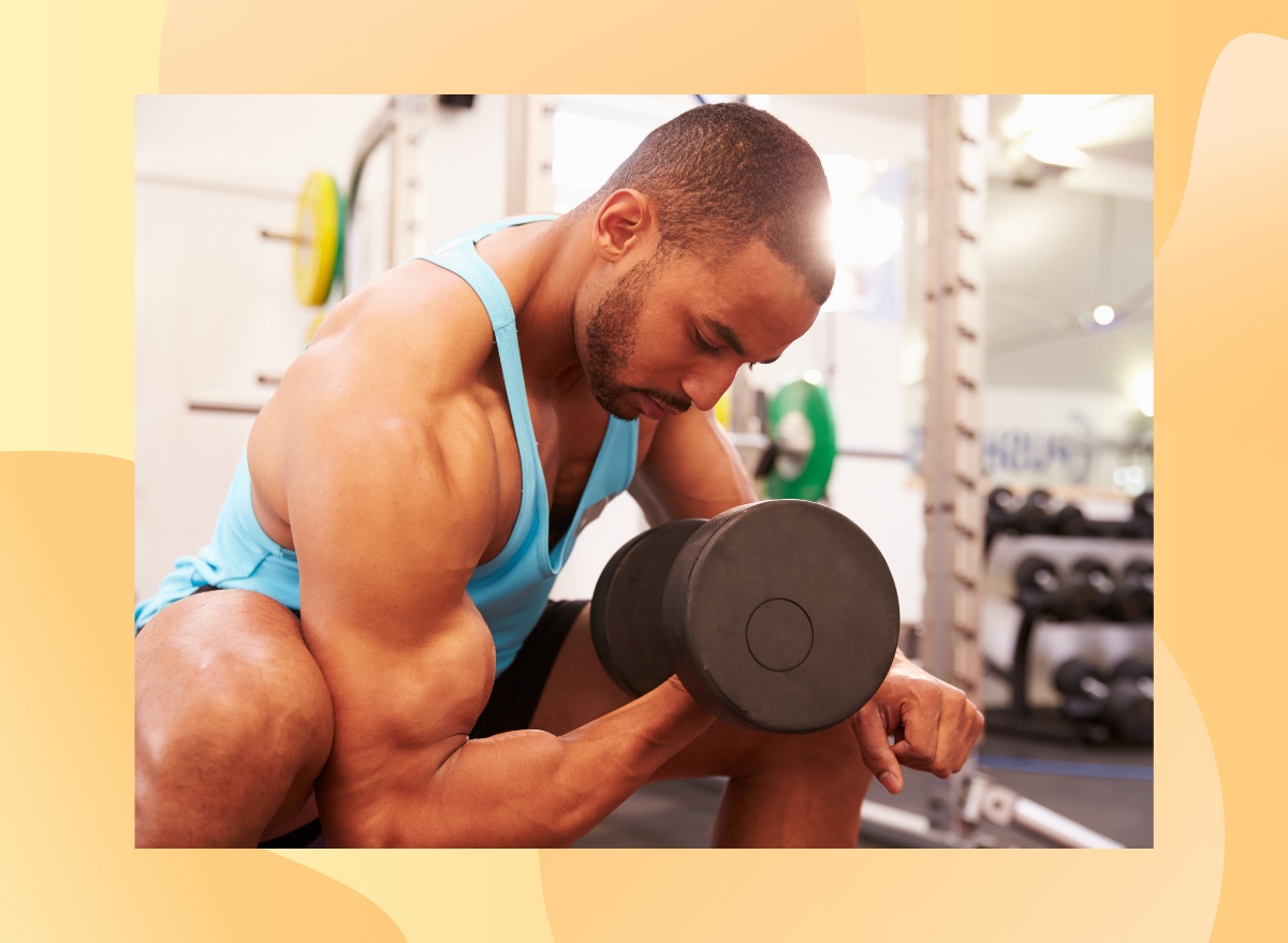 muscular man doing bicep curls at the gym