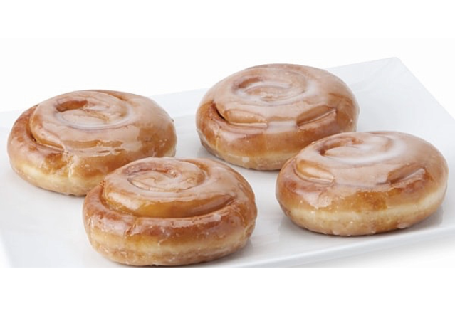 cinnamon roll donuts on a white plate.