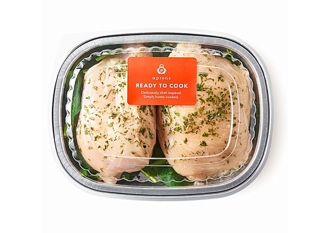two raw stuffed chicken breasts