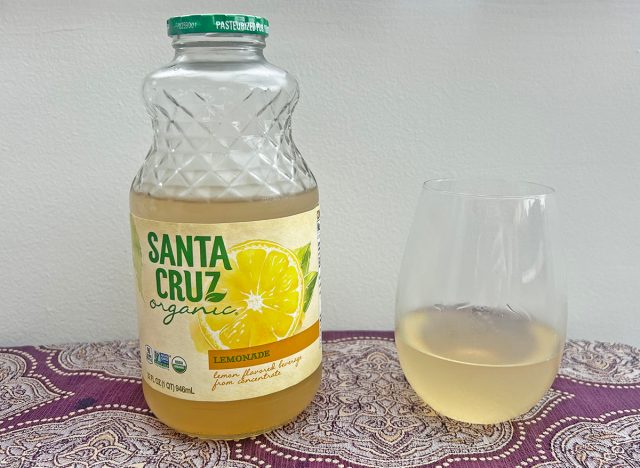 A bottle of Santa Cruz-brand lemonade beside a small glass of the beverage