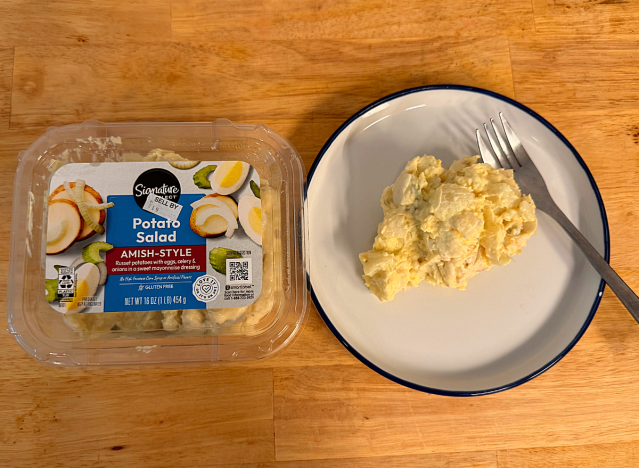 a container of potato salad next to a dish of potato salad 