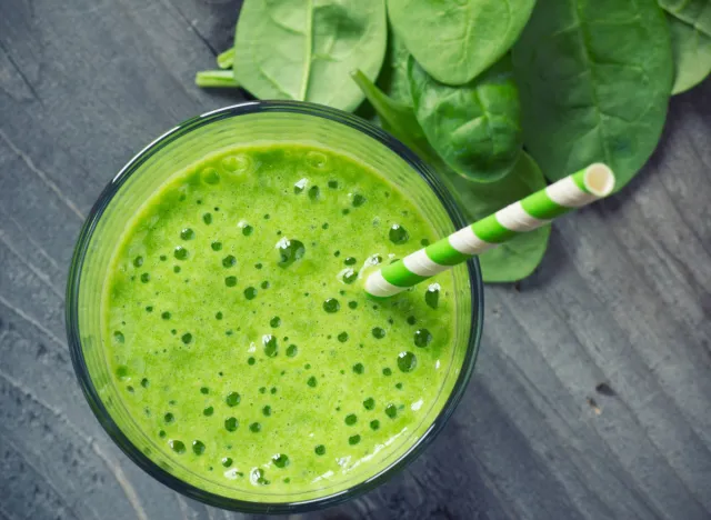 fresh spinach smoothie with straw
