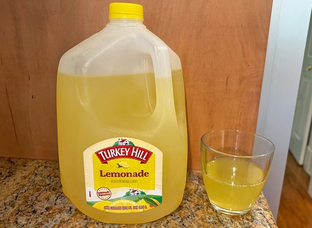 A jug of Turkey Hill brand lemonade next to a small glass of the beverage.