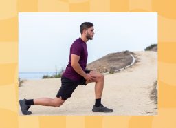 man in maroon t-shirt and black shorts doing walking lunges outdoors by the beach