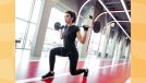 woman doing barbell lunges at the gym in front of windows