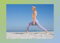 focused blonde woman doing dumbbell workout on beach on clear, sunny day