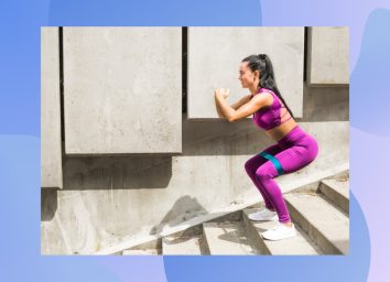 woman in purple athletic set doing squats with resistance band on steps